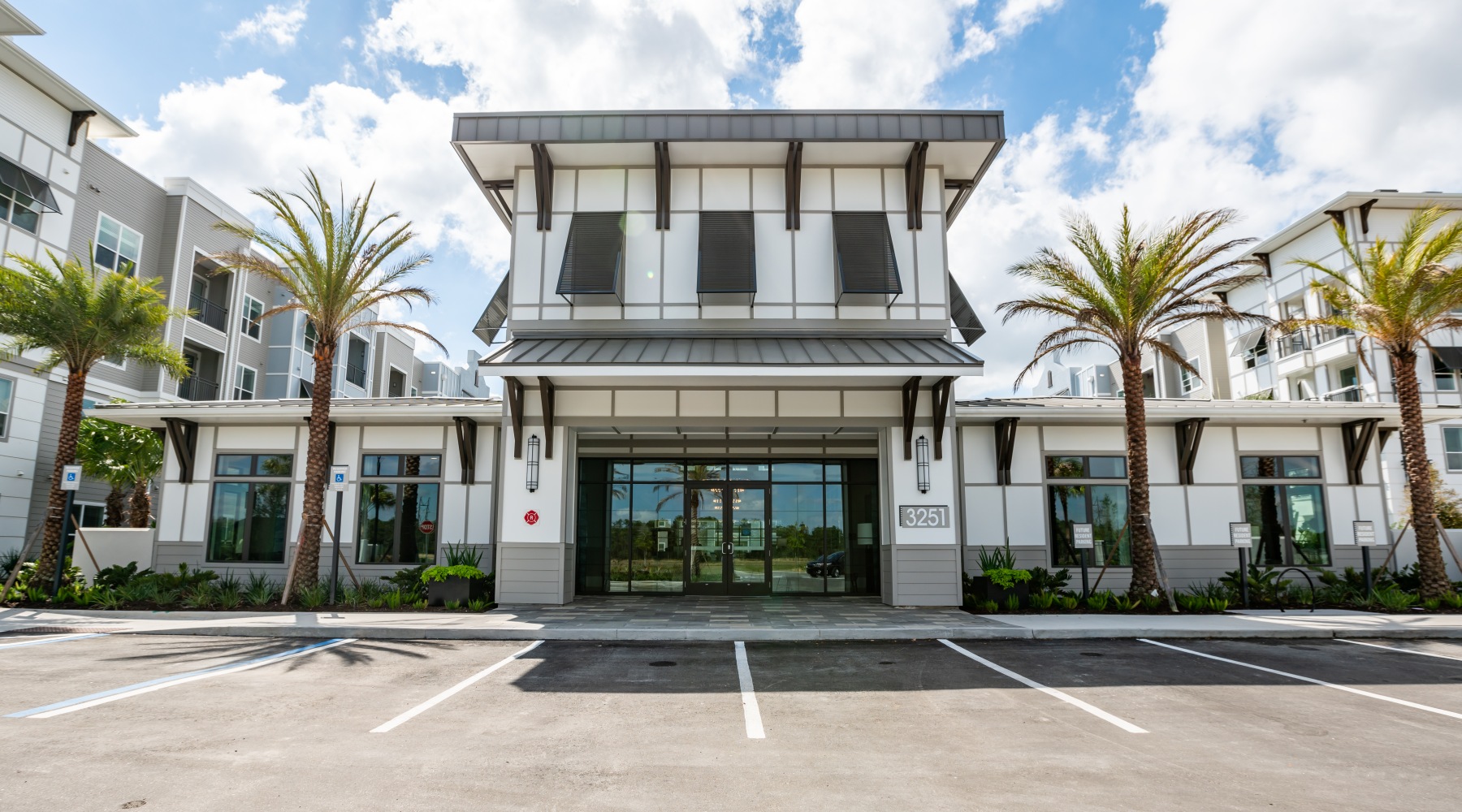 Luxury for a Lifetime Image of The Exterior of The Leasing Office with Palm Trees