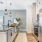 A modern kitchen interior at a Prime apartment home with stainless steel appliances, granite countertops, and pendant lighting