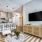 Modern floor plan at Prime featuring a kitchen with bar stools and pendant lights adjacent to a living area with a mounted television and wooden cabinet