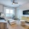 spacious living area with ample room for movement and natural lighting from large windows