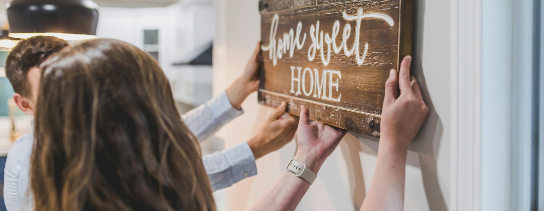 Image of Couple Hanging a Sign